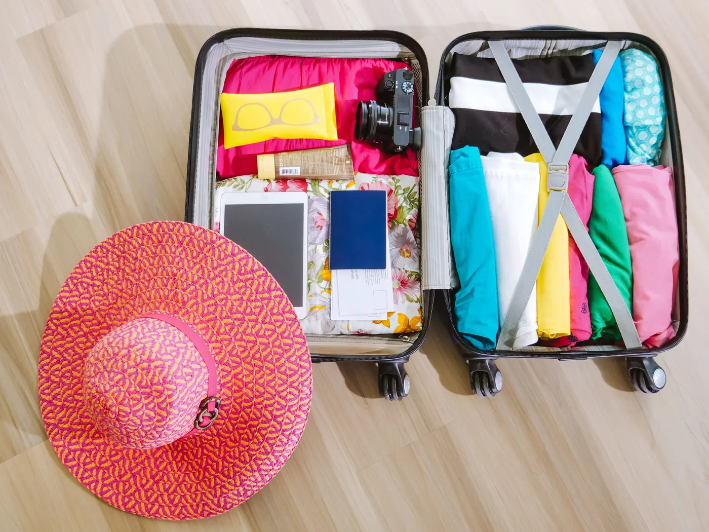 A packed suitcase with clothing and travel essentials laid out for a desert trip